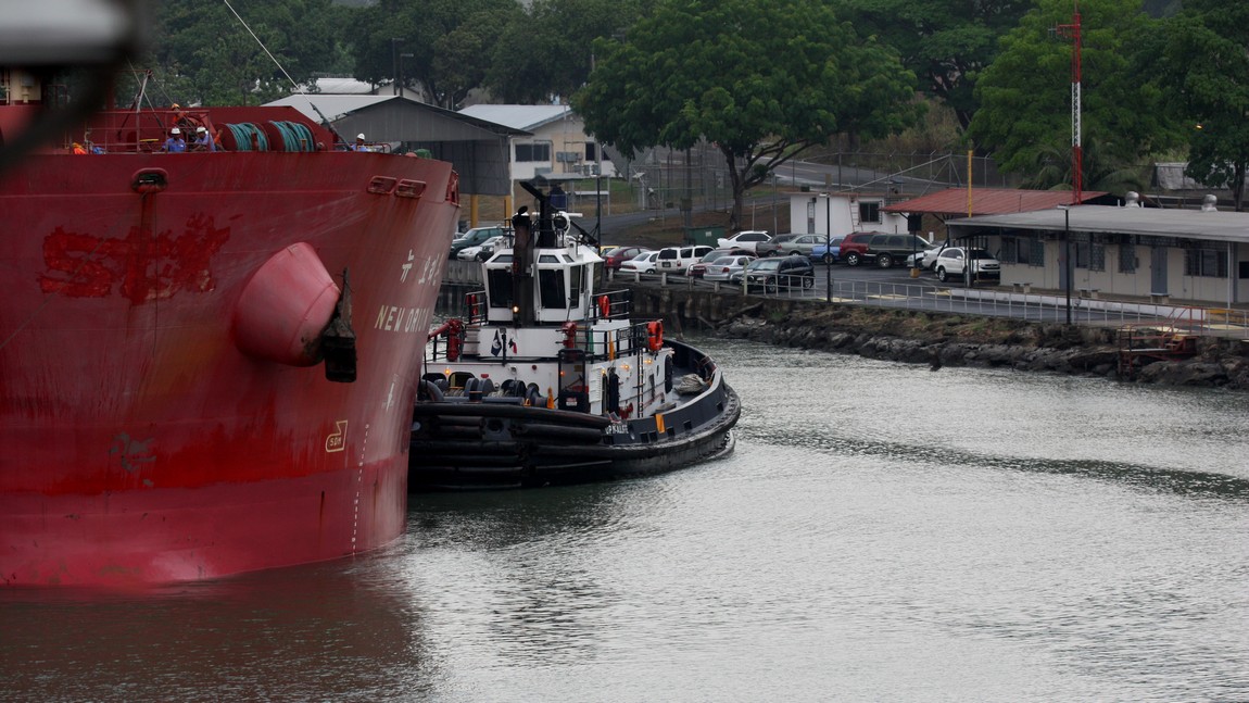 Tug boat helps guide the ship next to us