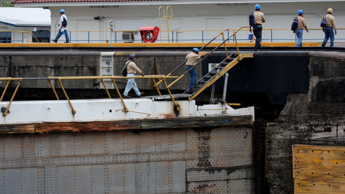 Workers cross from one side