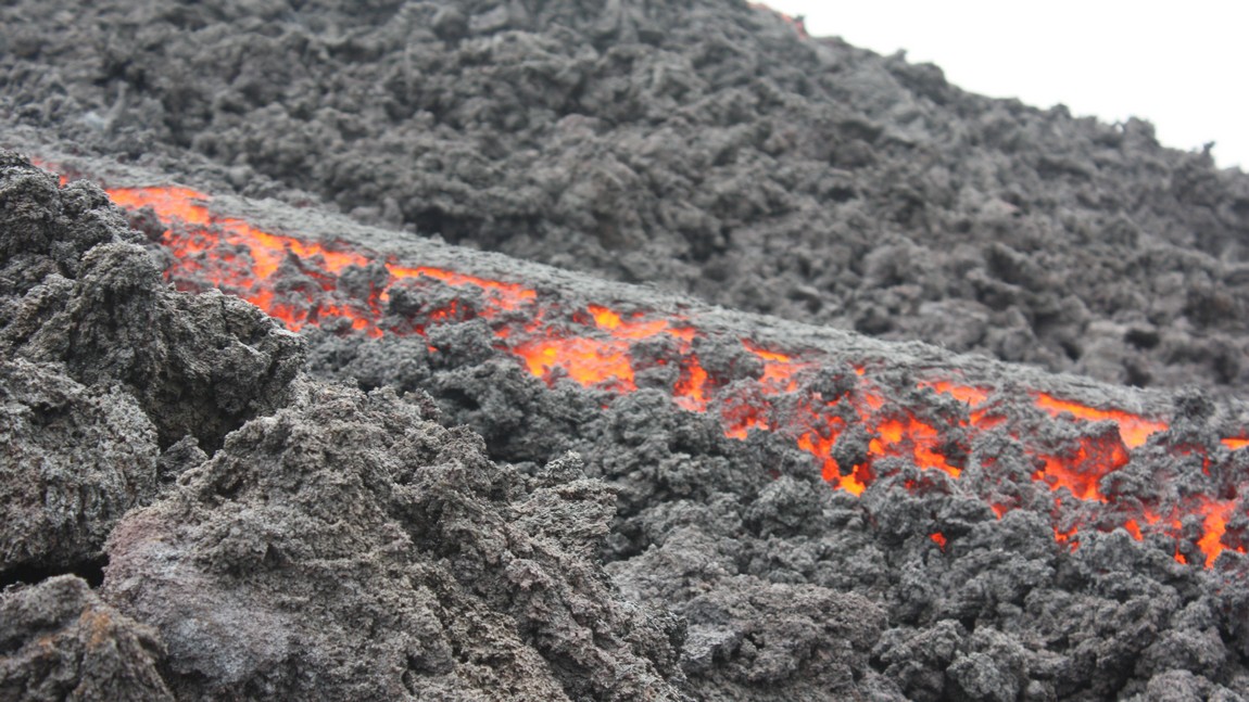 Next to the flowing lava