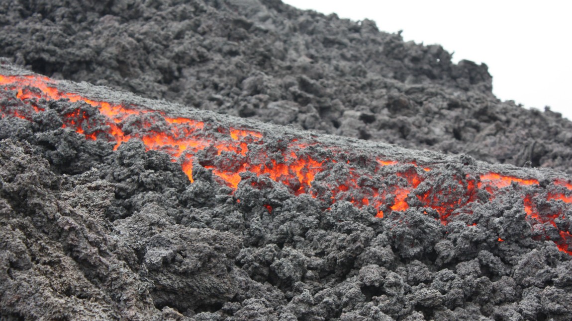 Next to the flowing lava