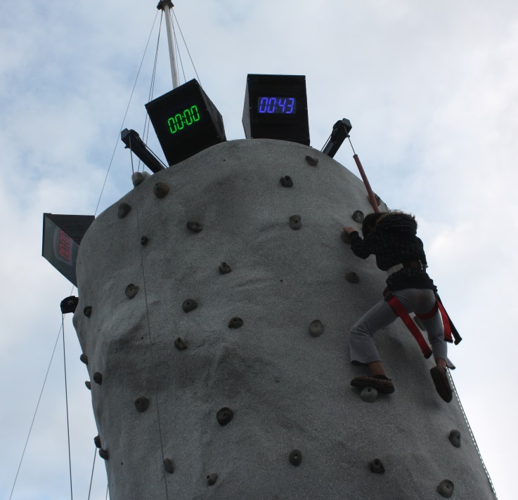 Young girl climbing the rock wall