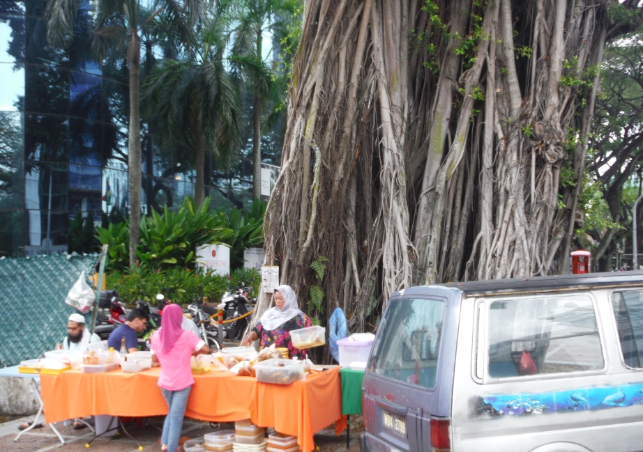 Note the remarkable tree behind the street vendors
