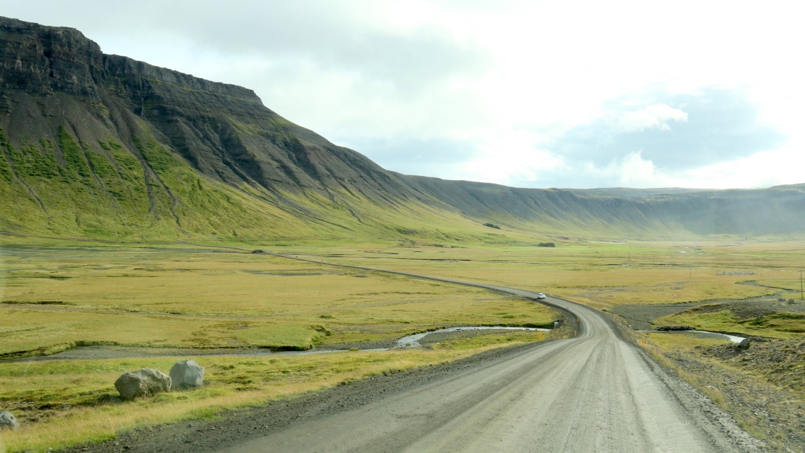 The road curves around the bottom of lftafjrur Bay