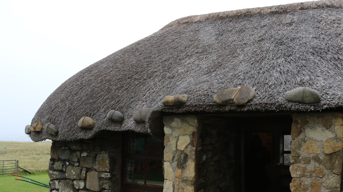 Stones are attached to the thatched roof