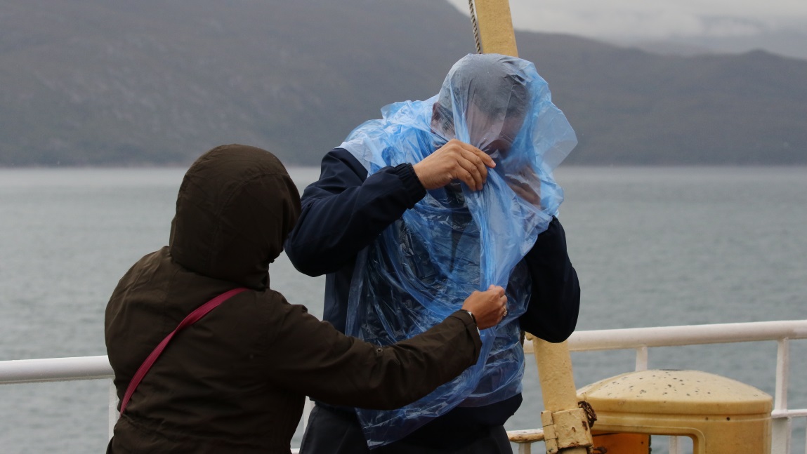 Attempting to put on a rain cover