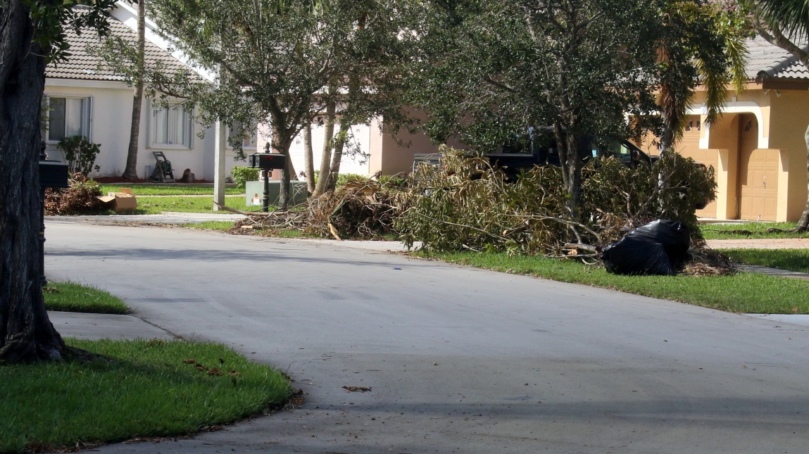 Debris piles down the street