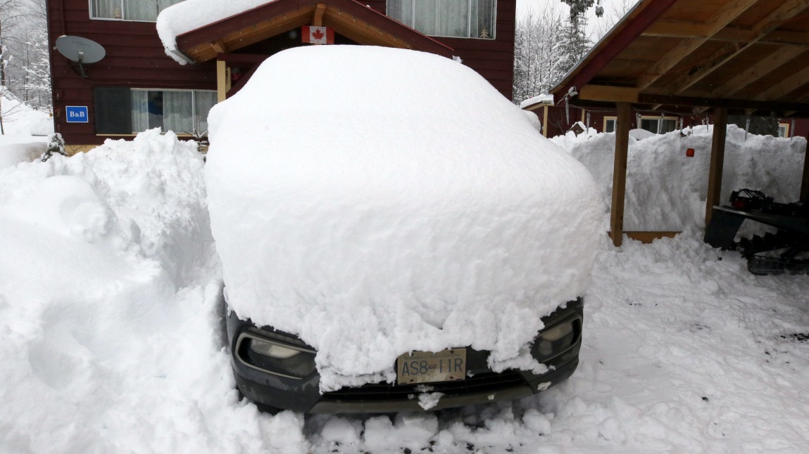 Our car buried under 13 inches of snow