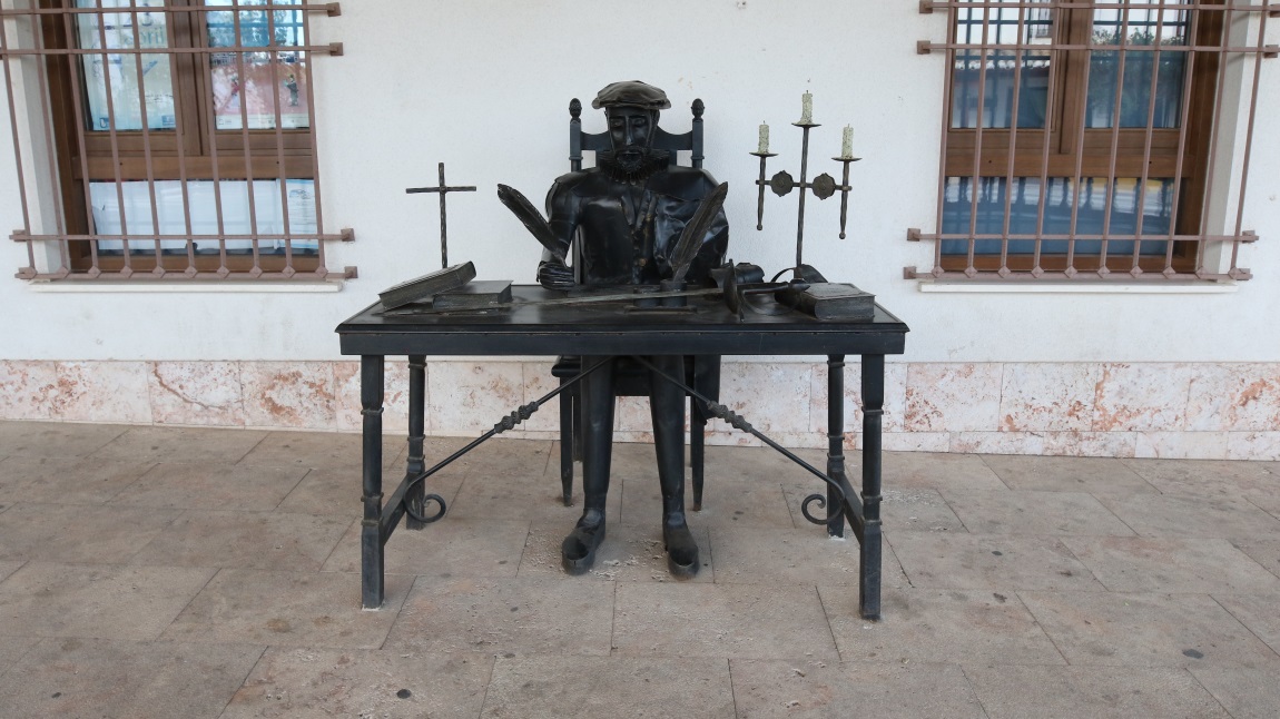 Miguel de Cervantes at his desk